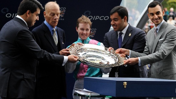 Trainer of Frankel Sir Henry Cecil and his Jockey Tom Queally are presented with the Qipco Champion Stakes trophy