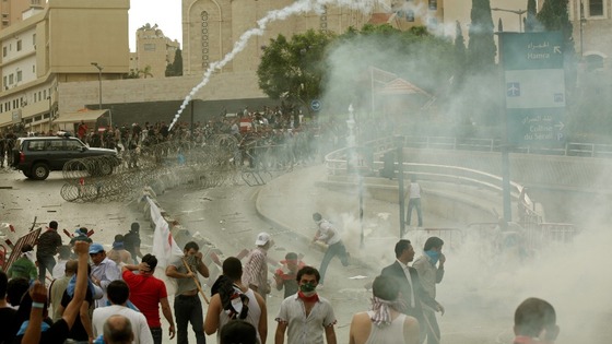 Lebanese policemen fire tear gas during clashes with angry protesters in Beirut