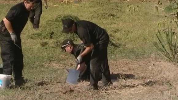 Police officers search
