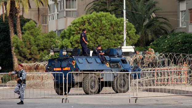 Lebanese Army soldiers and anti-riot police secure the area near the Prime Minister's residence in Tripoli.