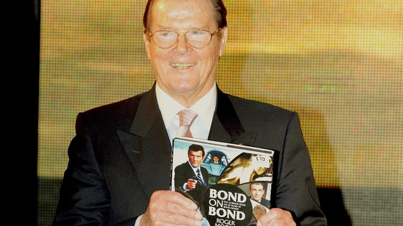 Sir Roger Moore poses with his new book 'Bond on Bond'