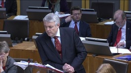 First Minister Carwyn Jones leaning on the lecturn