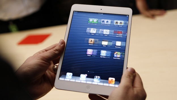 A visitor looks over the new iPad mini at the Apple event in San Jose