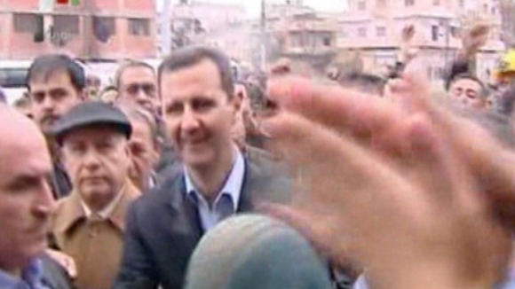 President Bashar Al-Assad is greeted by crowds in Homs.