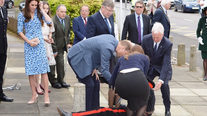 Prince William stooped to help the Queen's representative.