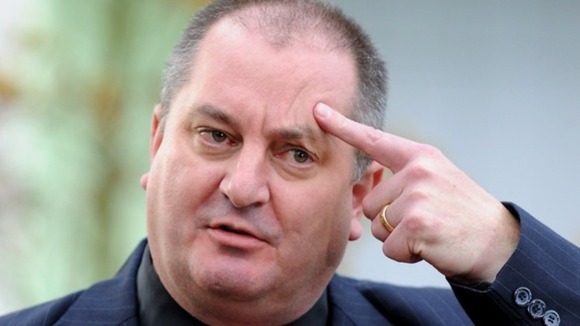 Doctor Dave Rosser from Queen Elizabeth Hospital in Birmingham points to his head as he describes Malala's gunshot wound