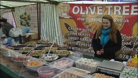 People sell international foods at the market 