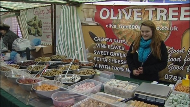 People sell international foods at the market