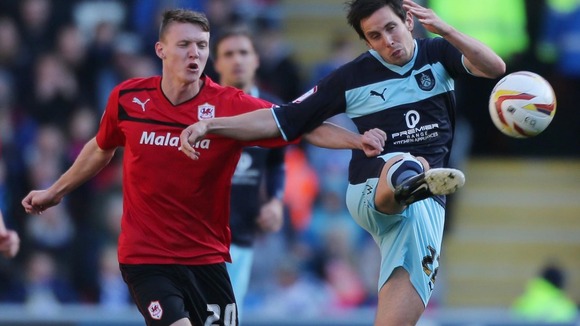 Cardiff City's Joe Mason and Burnley's Brian Stock battle for the ball during the npower Championship match at Cardiff City Stadium