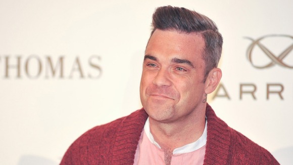 Take That star Robbie Williams helped the X Factor acts out with advice.