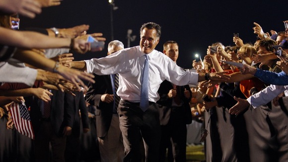 U.S. Republican Presidential nominee Mitt Romney leaves a campaign rally through a corridor of supporters in Land O'Lakes on Saturday.