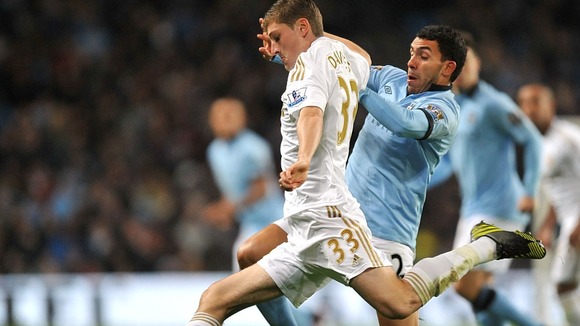 Swansea City's Ben Davies and Manchester City's Carlos Tevez