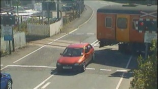 train nearly hits car