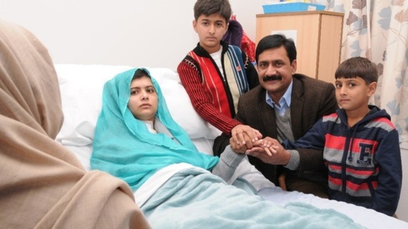 Malala Yousufzai with her family at her bedside