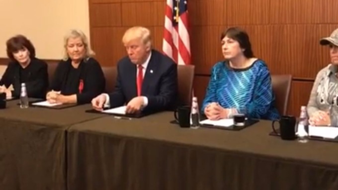 Trump at the presser with the four women.