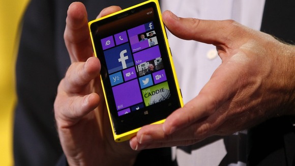 Microsoft CEO Steve Ballmer displays a Nokia Lumia 920 featuring Windows Phone 8 during an event in San Francisco