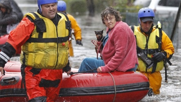 Emergency personnel rescue a resident from flood waters brought on by Hurricane Sandy in Little Ferry,