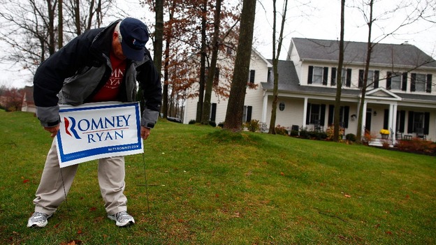 Volunteer Jeff Johnson installs a sign while canvassing for U.S. Republican presidential candidate Mitt Romney in Columbus, Ohio