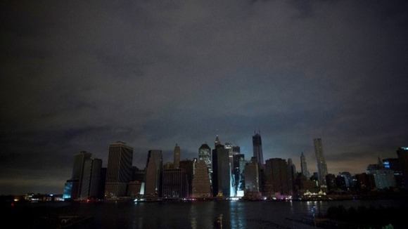 A largely unlit downtown Manhattan stands under a night sky due to a power blackout caused by Hurricane Sandy in New York.