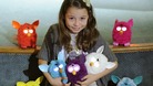 A child poses with Furby toys