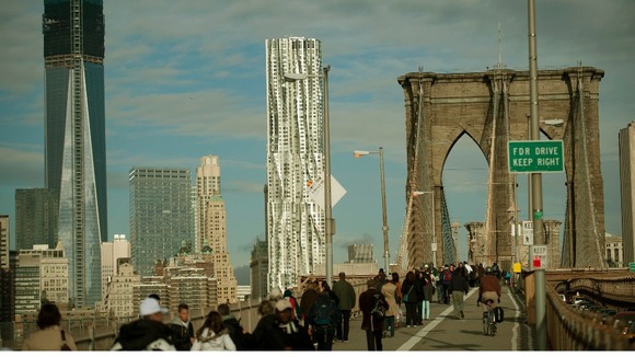 Commuters make their way across the Brooklyn Bridge in New York.