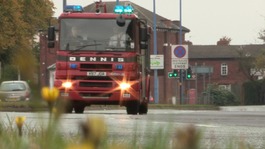 Fire engine along road with siren lit