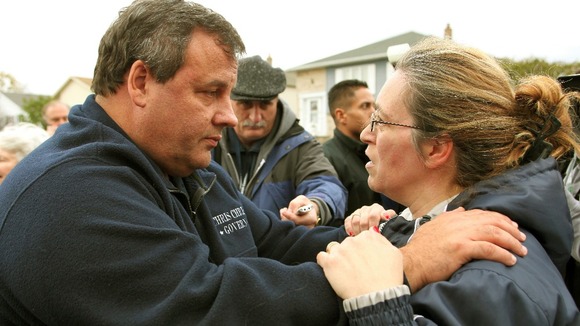 Governor Chris Christie consoles local Alice Cimillo while touring Moonachie, New Jersey