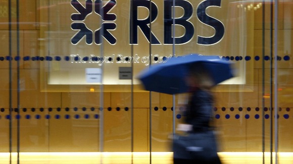 File photo of a woman walking past the headquarters of the Royal Bank of Scotland in the City of London