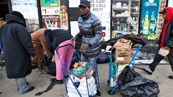 People look for salvageable food discarded from a flooded store in Coney Island, New York, on Friday.
