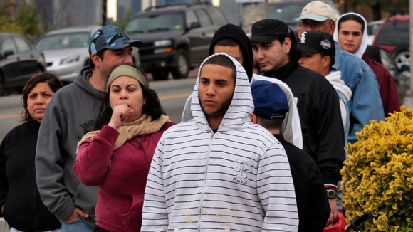 People wait in line to buy gas at a station at Union City, New Jersey.