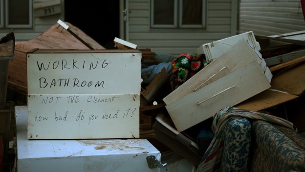 A message is left on flooded belongings outside a house hit by hurricane Sandy