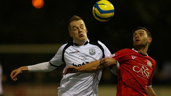 Cambridge City's Joey Abbs and Milton Keynes Dons' Jay O'Shea