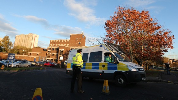 A police officer stands at the entrance to Baird Street Police Station in Glasgow