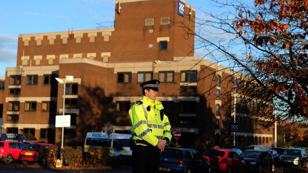 A police officer stands at the entrance to Baird Street Police Station in Glasgow 