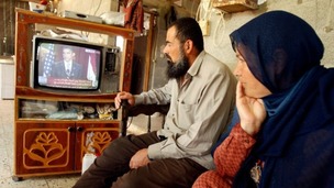 Palestinians watch speech by US President Barack Obama at their house in the southern Gaza Strip in 2009.