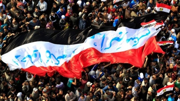 Egyptian protesters march with a huge flag during a rally at Tahrir Square in Cairo in 2011.