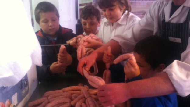 School children in Telford having a go at making sausages