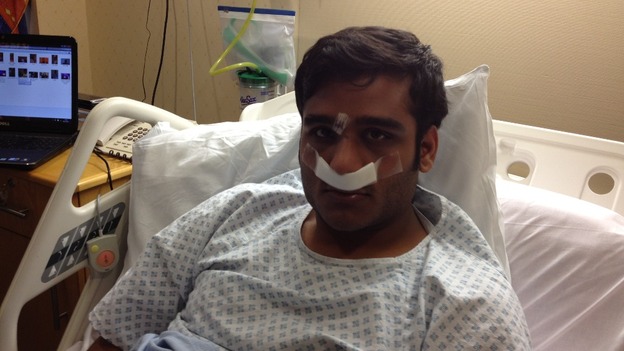 Ummad Farooq in bed after pioneering surgery at the Queen Elizabeth hospital