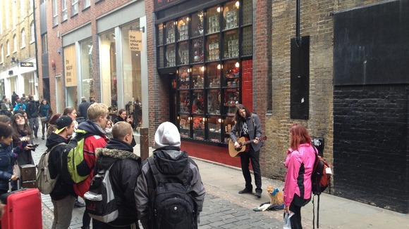 James Bowen performs in Covent Garden with Bob the cat by his side.