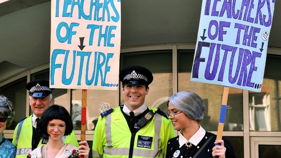Students join their teachers demonstrating outside the Department of Education.