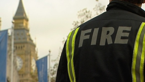 A firefighter in the shadow of Big Ben lobbying against cuts to the fire service