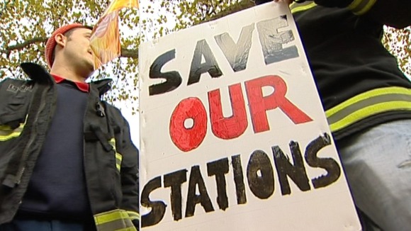 Placards against the closure of fire stations which union members say will happen if the service is cut further