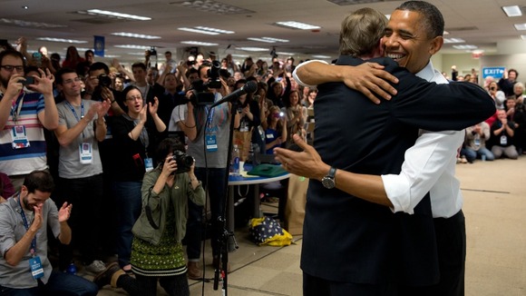 President Obama hugs his campaign manager, Jim Messina, during an unannounced stop at his campaign headquarters in Chicago.