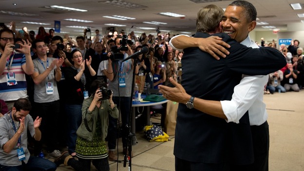 President Obama hugs his campaign manager, Jim Messina, during an unannounced stop at his campaign headquarters in Chicago.