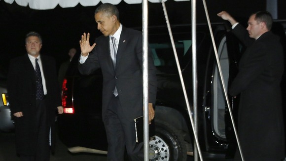 President Obama waves to reporters as he makes his way back to the White House.