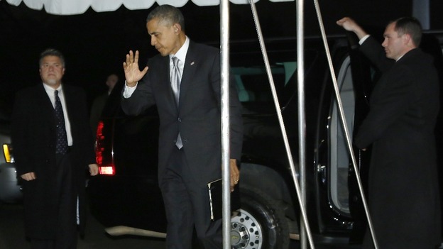 President Obama waves to reporters as he makes his way back to the White House.