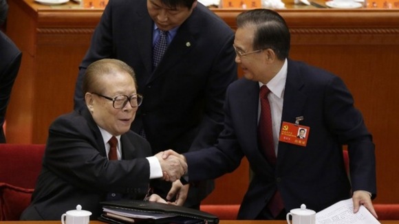 China's former President Jiang shakes hands with Premier Wen.