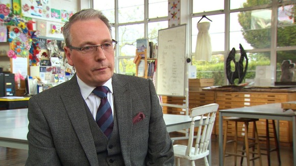 Headmaster sitting in classroom