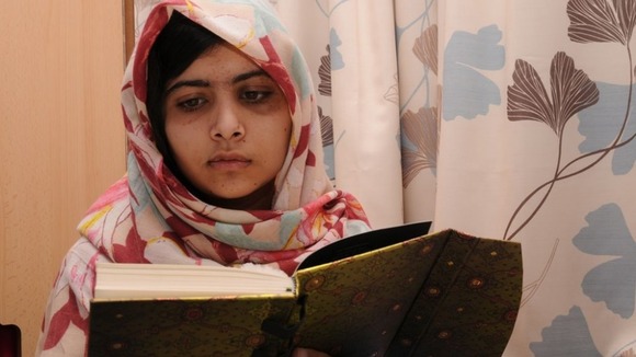 The 15-year-old education campaigner reads well-wishers cards.