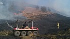 Firefighters fighting grass fire